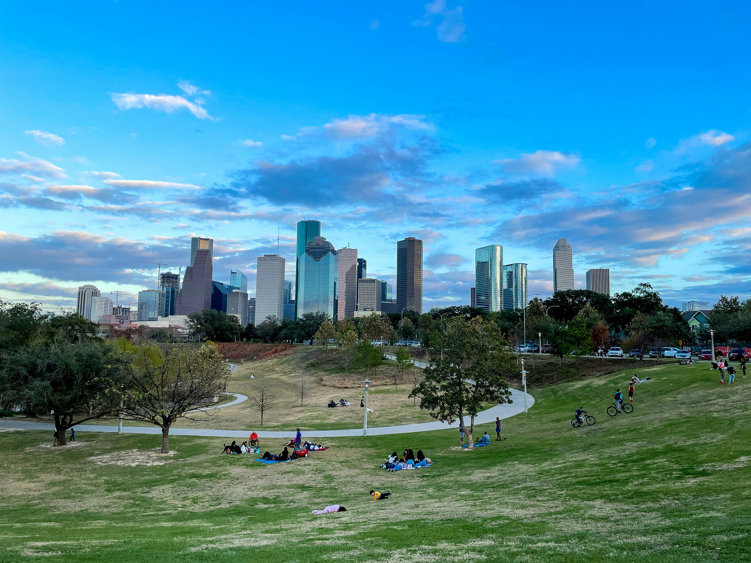Houston skyline viewed across Buffalo Bayou Park at dusk